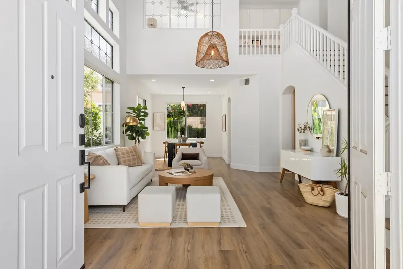 Living room looking toward the staircase with vinyl wood plank flooring at 5353 Renaissance Ave San Diego