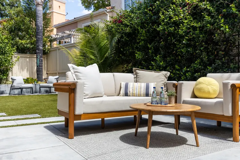 Patio sofa detail with cushions and a low wood coffee table at 5353 Renaissance Ave San Diego