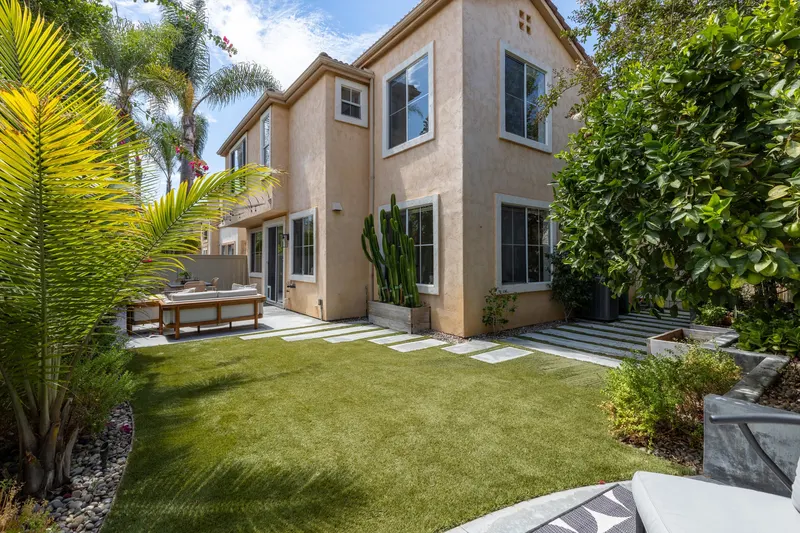 Backyard lawn looking back toward the rear elevation of the home at 5353 Renaissance Ave San Diego