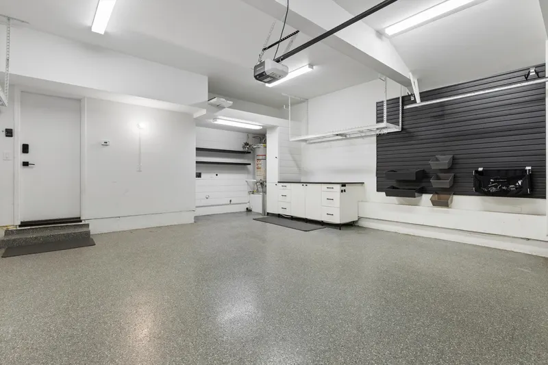 Attached two-car garage with epoxy-coated floor and built-in storage at 5353 Renaissance Ave San Diego