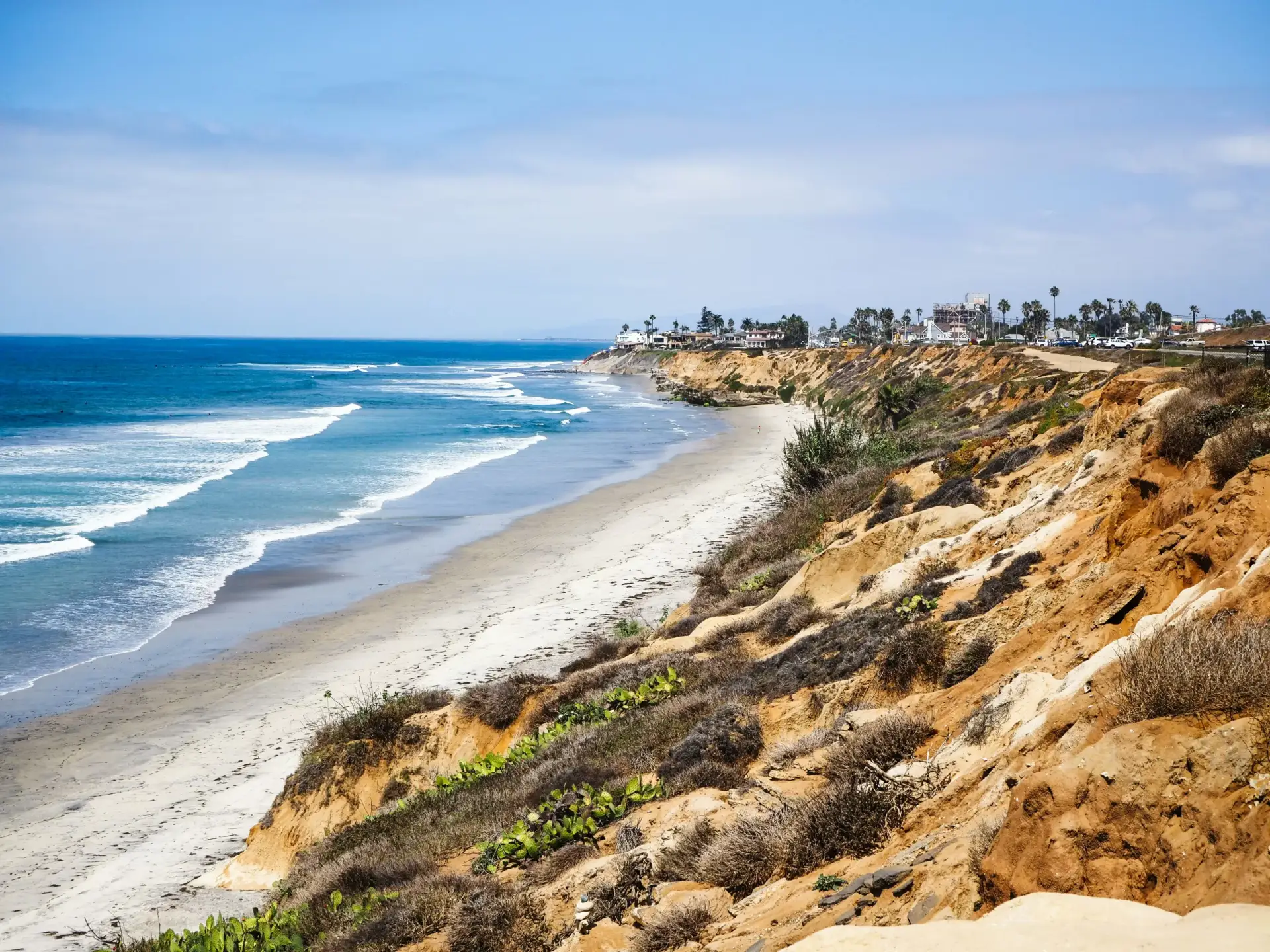 The coastal bluffs and beach in Carlsbad, looking north along the shoreline.