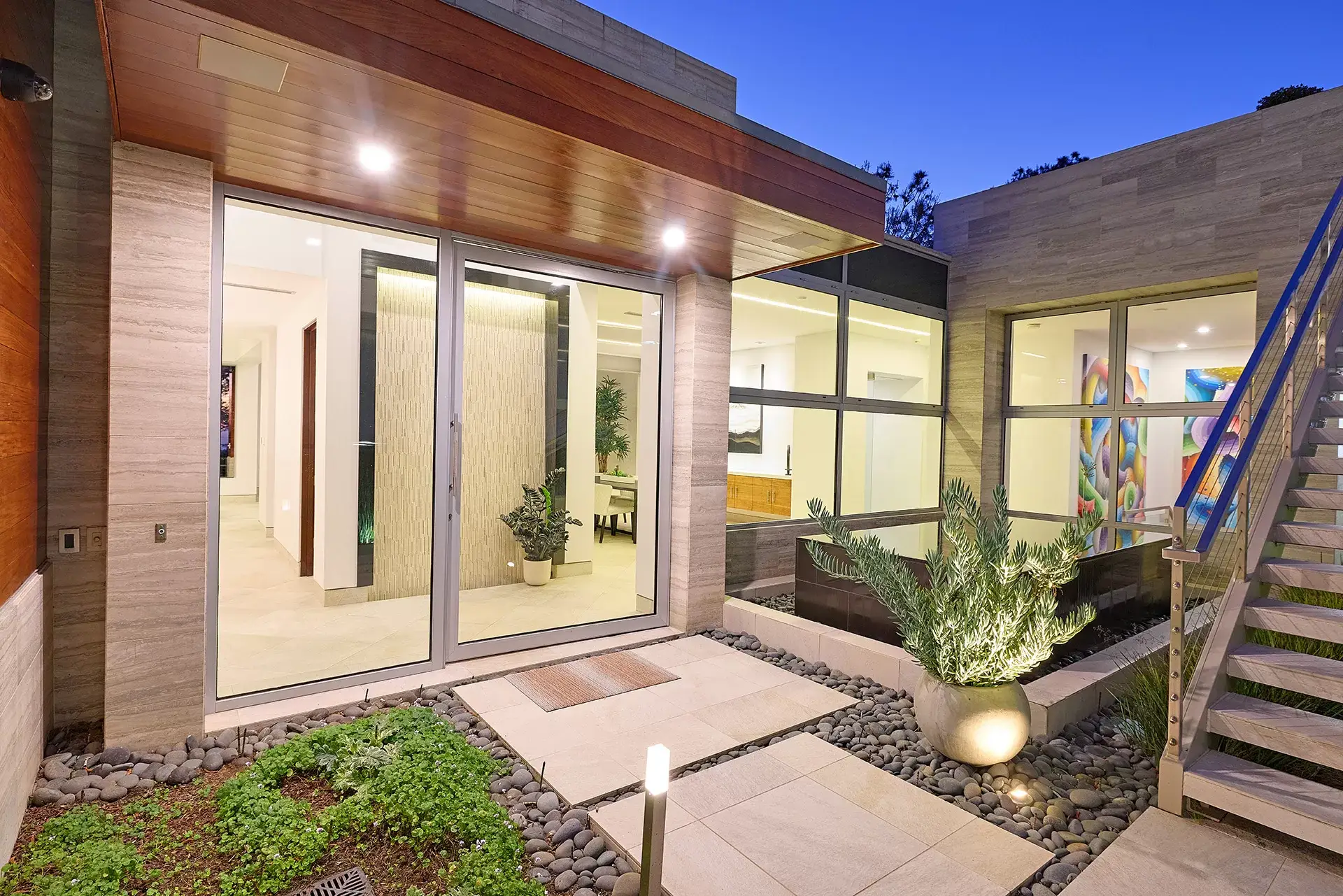 Modern courtyard entry with floor-to-ceiling glass walls and landscaped gardens at 116 Nob Ave Del Mar listed by Kelli Miller Compass