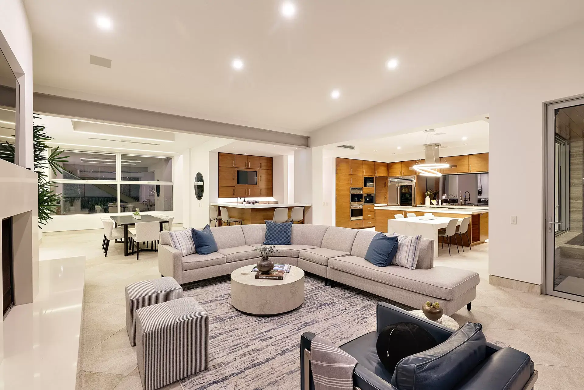 Open concept living room and kitchen with disappearing glass walls and natural light at 116 Nob Ave Del Mar luxury home listed by Kelli Miller Compass