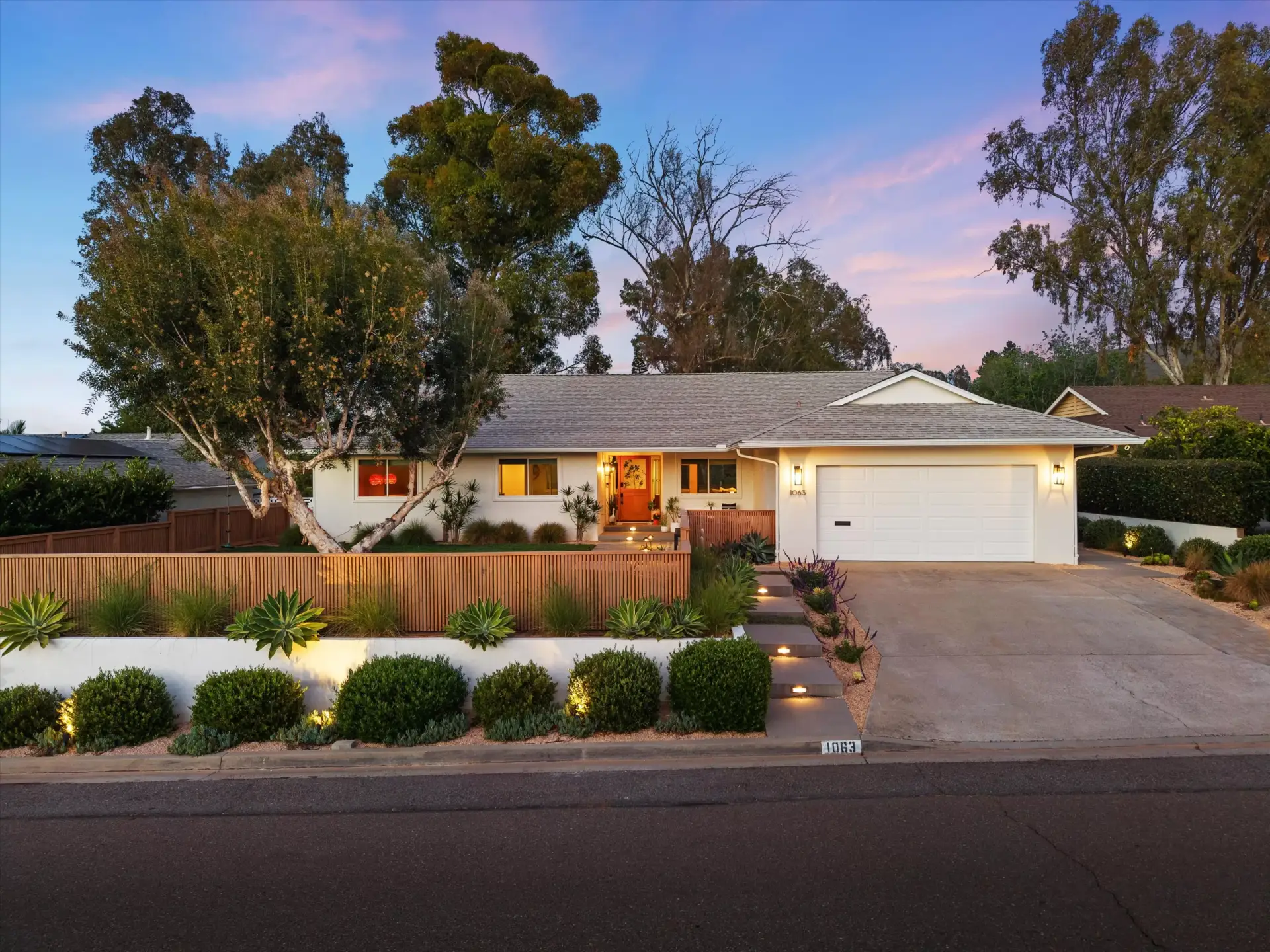 Front exterior with new stucco and landscaping at twilight at 1063 San Julian Dr San Marcos listed by Kelli Miller Compass