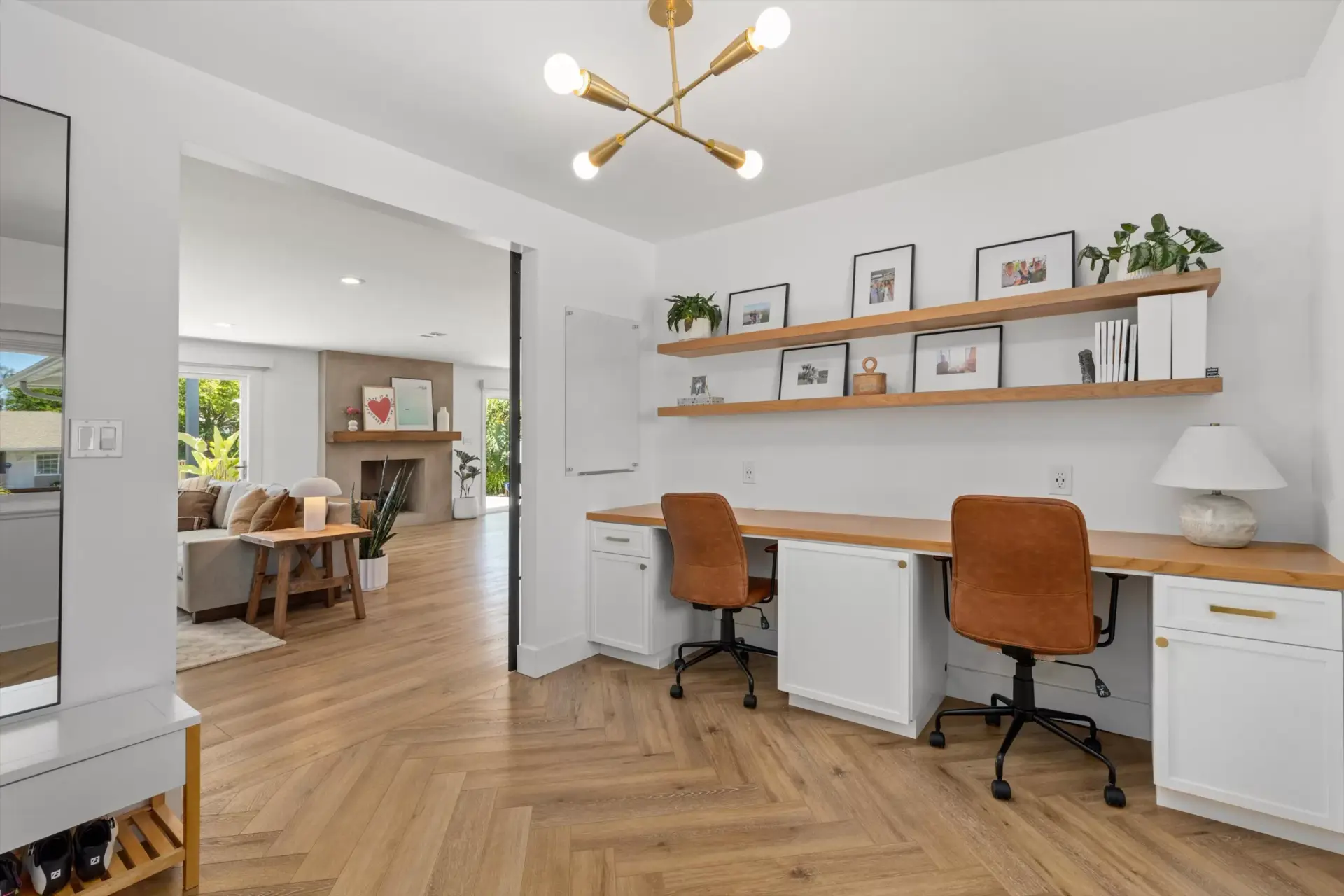 Home office with built-in desk for two, cabinetry and floating shelves at 1063 San Julian Dr San Marcos listed by Kelli Miller Compass