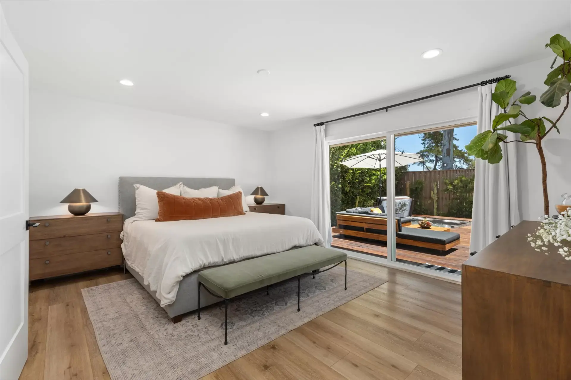 Primary suite with sliding glass door to the backyard deck and jacuzzi at 1063 San Julian Dr San Marcos listed by Kelli Miller Compass