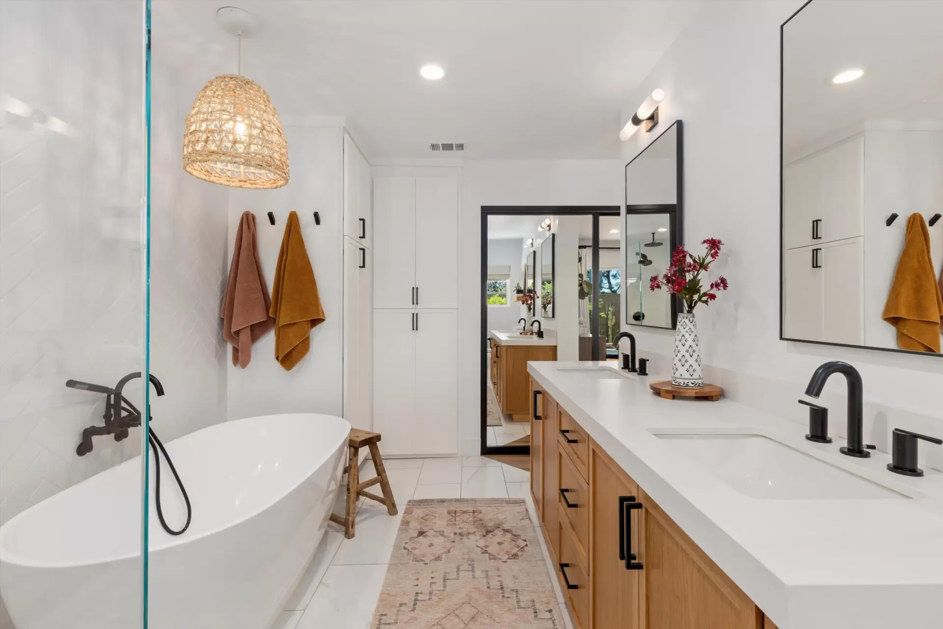 Primary bathroom with custom glass shower, rainfall showerhead and freestanding soaking tub at 1063 San Julian Dr San Marcos listed by Kelli Miller Compass