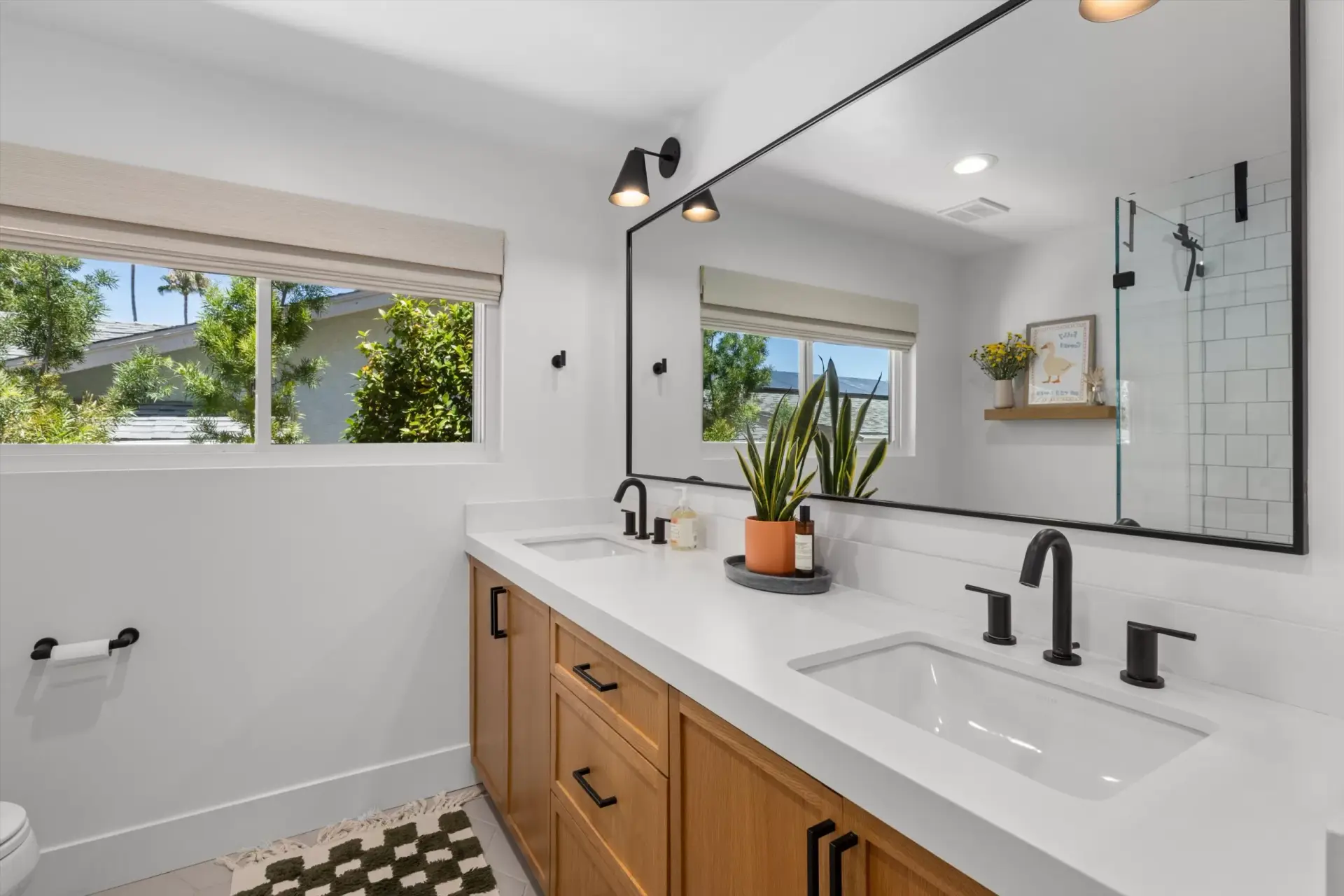 Guest bathroom with dual-sink vanity and tiled shower at 1063 San Julian Dr San Marcos listed by Kelli Miller Compass