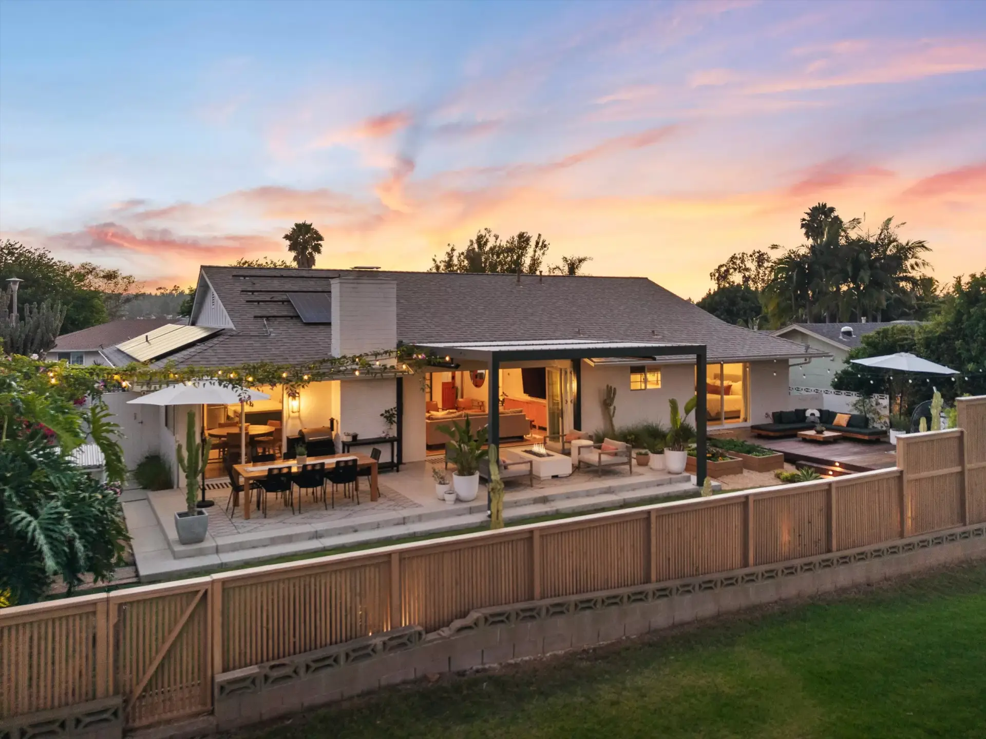 Backyard patio, lawn and covered lounge at twilight at 1063 San Julian Dr San Marcos listed by Kelli Miller Compass