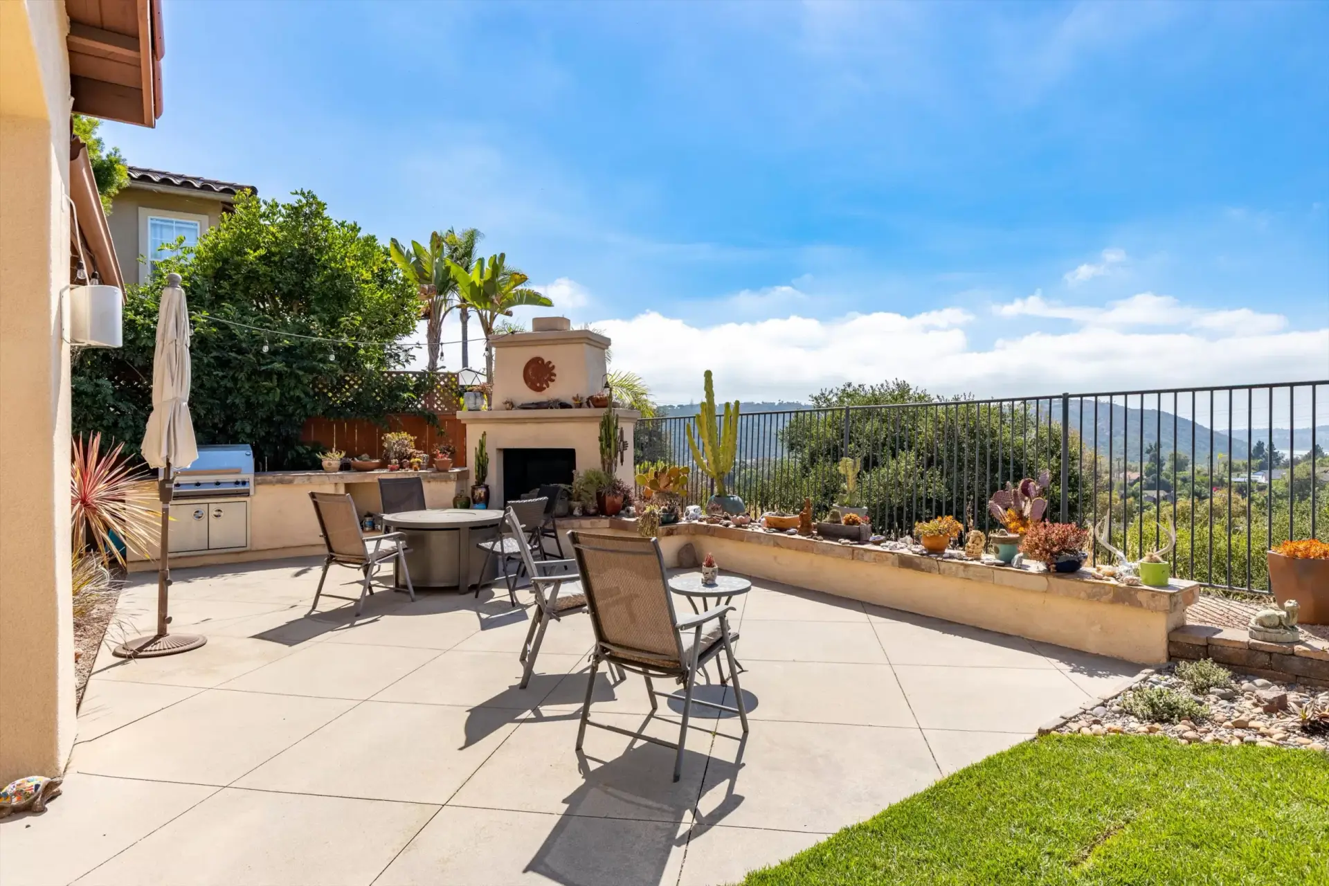 Backyard patio with outdoor fireplace and Batiquitos Lagoon views at 2198 Vista La Nisa Carlsbad Mediterranean estate listed by Kelli Miller Compass