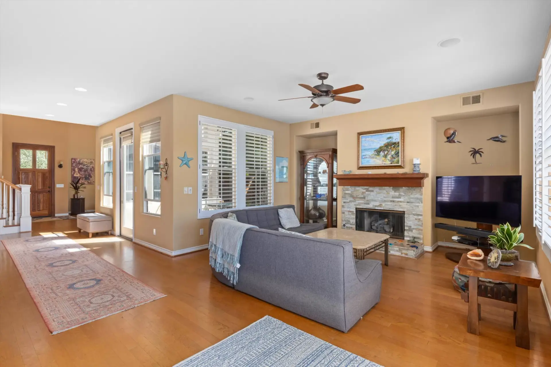 Living room with fireplace and front entry at 2198 Vista La Nisa Carlsbad listed by Kelli Miller Compass