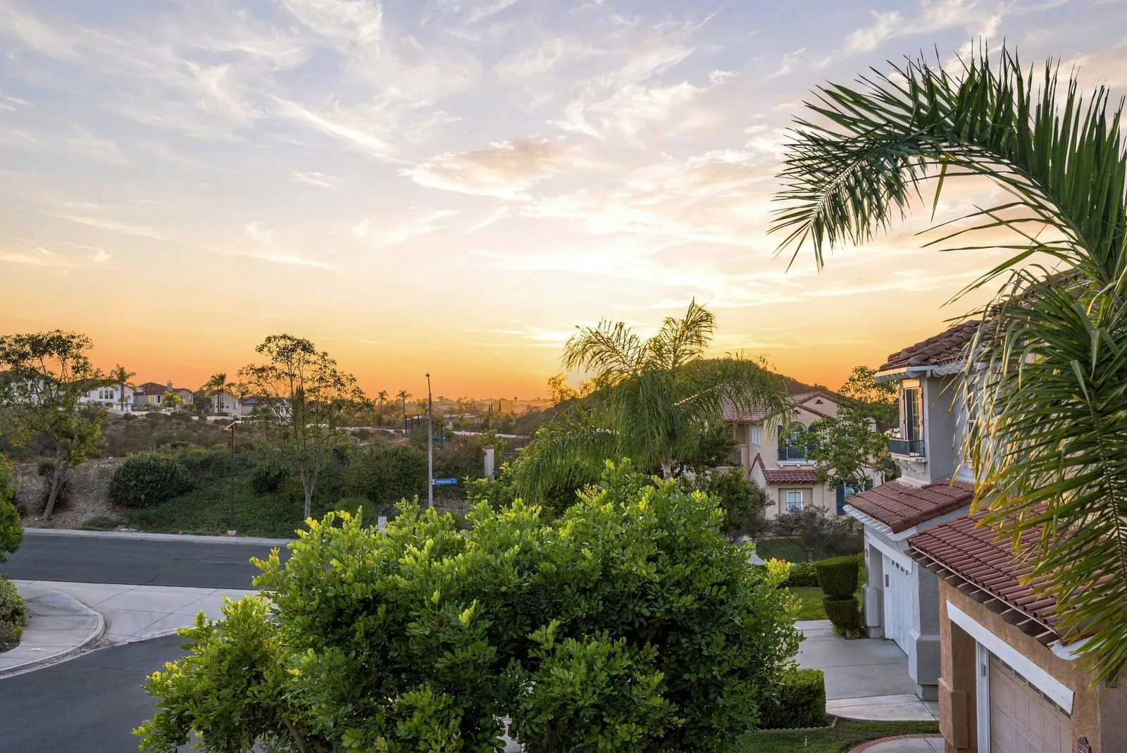 Sunset over the canyon and the cul-de-sac seen from the second-story balcony at 12086 Little Silver Ct, Scripps Ranch, San Diego