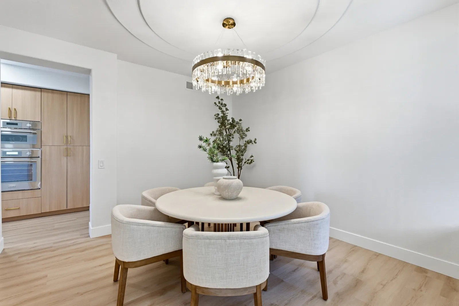 Dining room with round table and crystal chandelier at 12086 Little Silver Ct, Scripps Ranch, San Diego