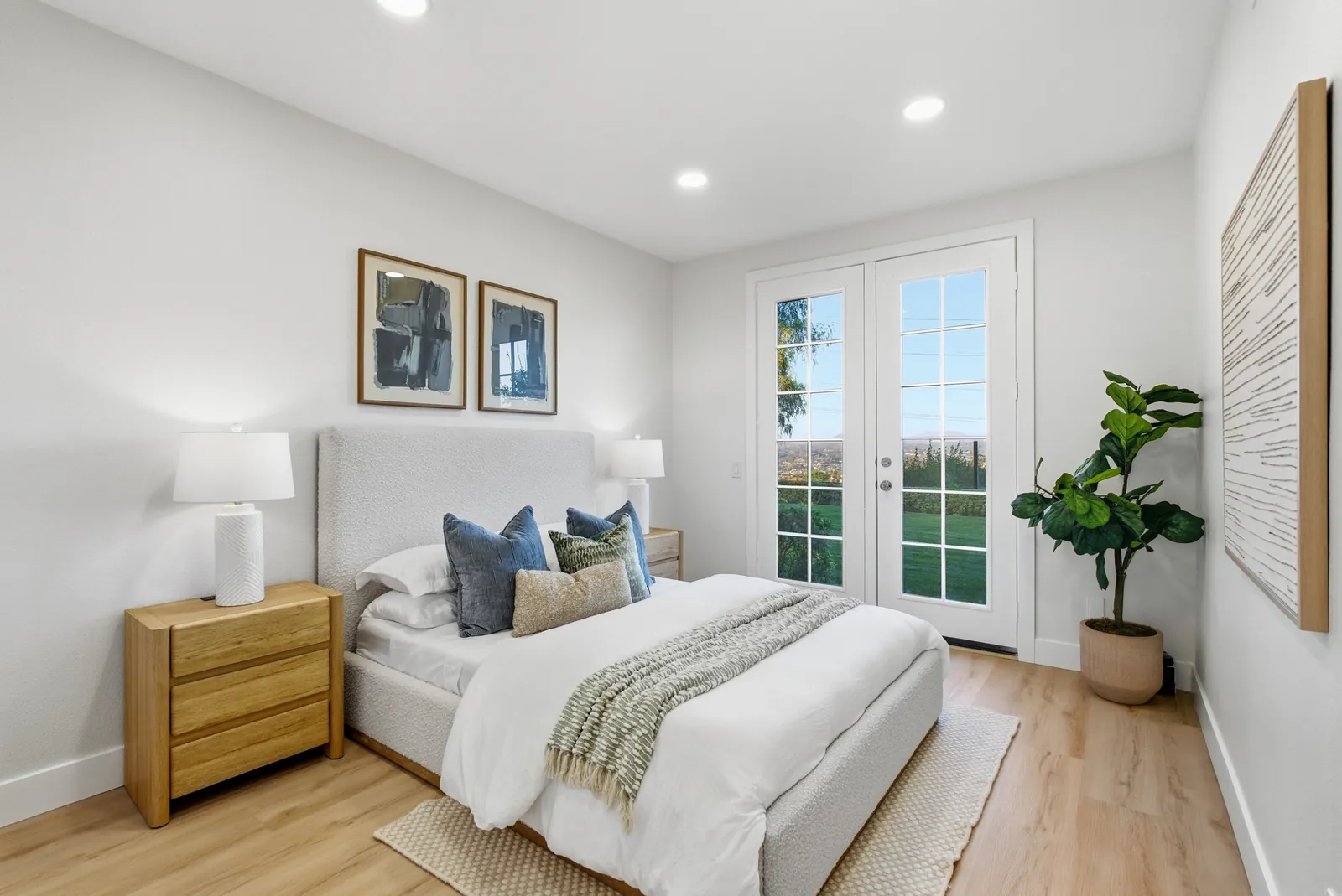 Downstairs bedroom with French doors opening to the backyard lawn at 12086 Little Silver Ct, Scripps Ranch, San Diego