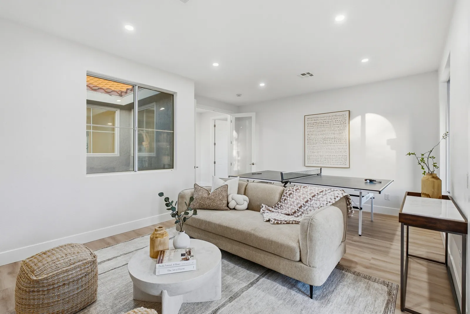 Upstairs game room staged with a sofa and ping-pong table at 12086 Little Silver Ct, Scripps Ranch, San Diego