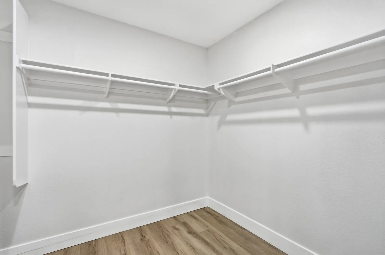 Primary suite walk-in closet with hanging rods and shelving at 12086 Little Silver Ct, Scripps Ranch, San Diego