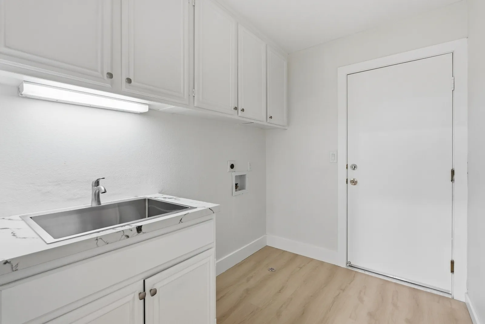 Laundry room with sink, cabinetry and door to the garage at 12086 Little Silver Ct, Scripps Ranch, San Diego