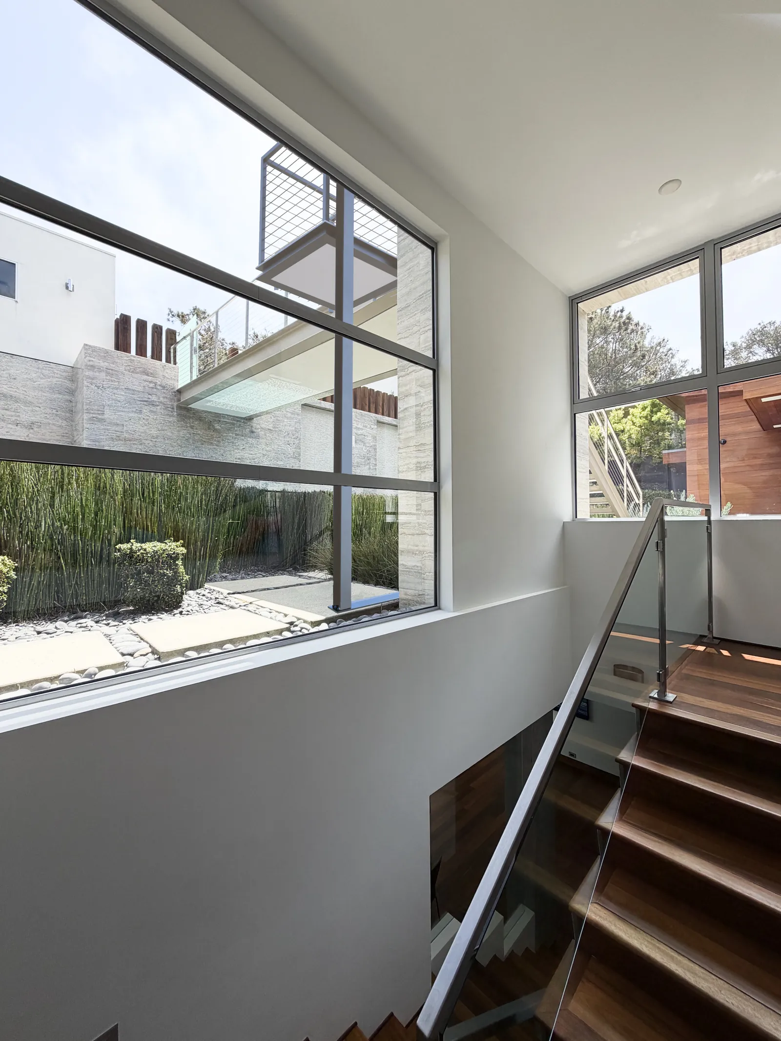 Conceptual rendering of the proposed lift seen through the interior stairwell window at 116 Nob Ave Del Mar listed by Kelli Miller, Encinitas Realtor | Compass