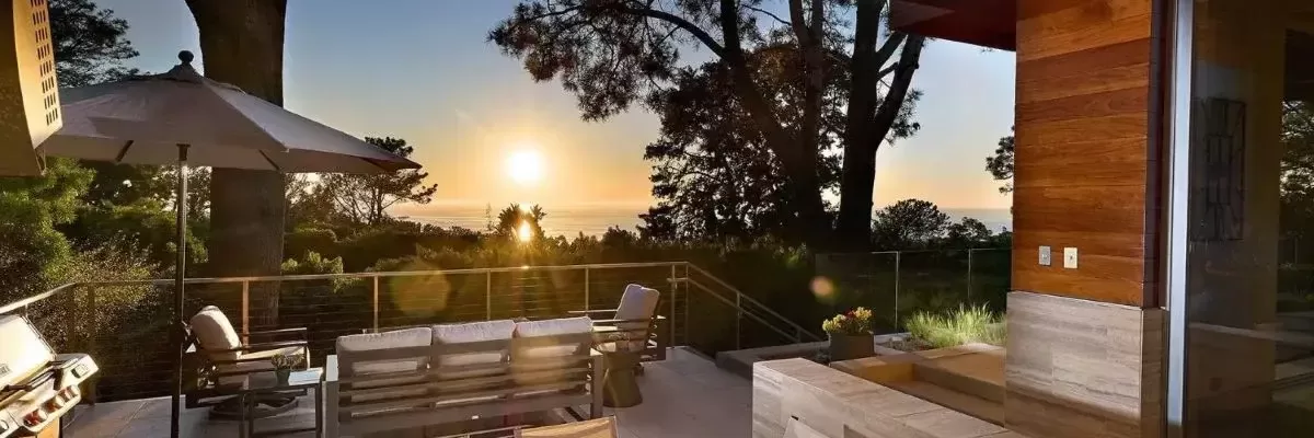 Represented by Kelli Miller, this covered outdoor terrace in Olde Del Mar captures stunning sunset views over the Pacific Ocean and surrounding Torrey Pines. Designed for seamless indoor-outdoor living, the space features warm wood-clad ceilings with built-in radiant heaters, dynamic seating and dining areas, and direct access to the main living spaces. Part of a premier 5,441 sq. ft. private coastal retreat.